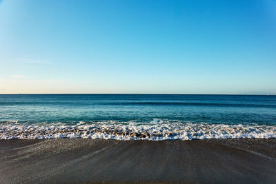 Scenic view of sea against clear blue sky