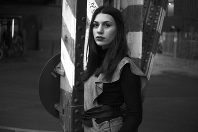 Portrait of young woman standing outdoors