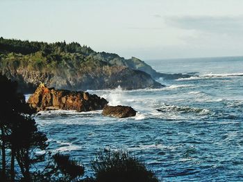 Scenic view of sea and rock formation against sky