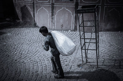 Rear view of woman walking on street