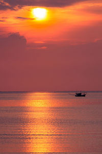 Scenic view of seashore at sunset