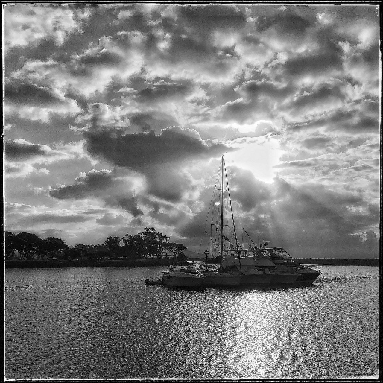 SAILBOAT BY SEA AGAINST SKY