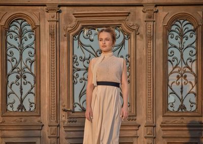 Portrait of beautiful young woman standing in corridor