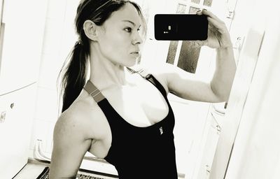 Portrait of woman photographing with smart phone