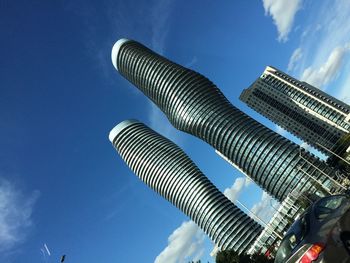 Low angle view of skyscrapers against blue sky