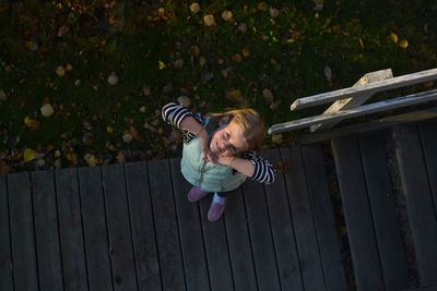 High angle view of girl with arms outstretched