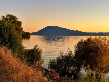 Scenic view of lake against sky during sunset