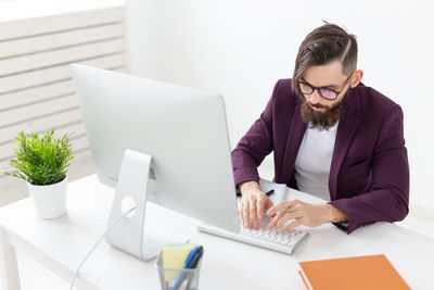 Mid adult man using laptop on table