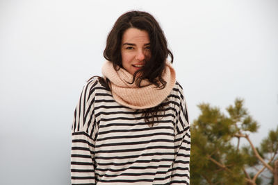 Portrait of young woman wearing striped top during foggy weather