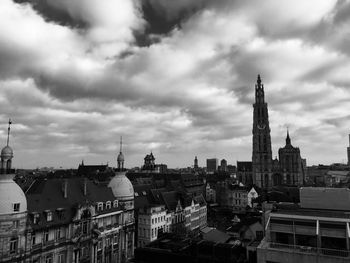 View of cityscape against cloudy sky