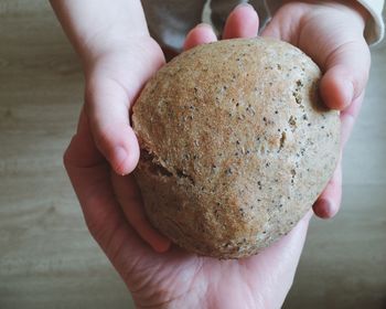 Cropped hands holding bread