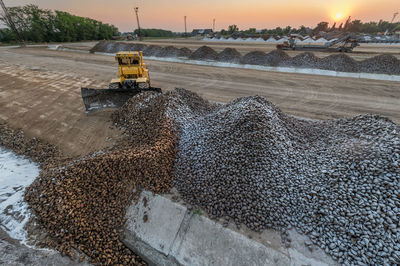 High angle view construction vehicle at site during sunset