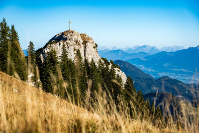 Scenic view of mountains against blue sky