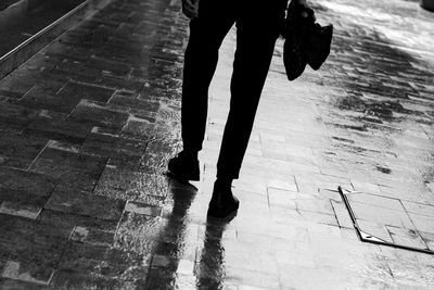 Low section of person standing on footpath