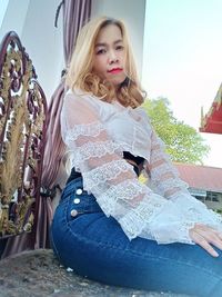 Portrait of young woman sitting outdoors