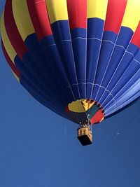 Low angle view of hot air balloon against blue sky