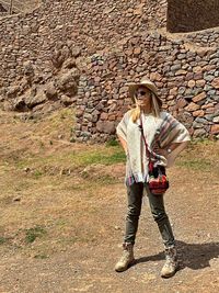 Portrait of young woman wearing sunglasses standing outdoors