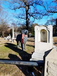 Tombstones in cemetery against sky