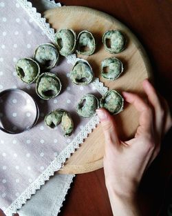 Close-up of hand holding tortellini