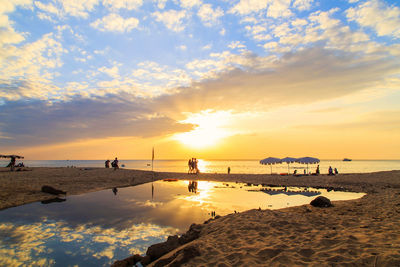 Scenic view of beach against sky during sunset