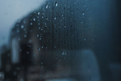 Close-up of raindrops on glass window