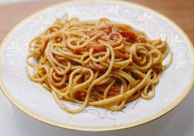 Close-up of spaghetti served in plate on table