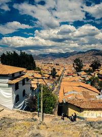 High angle view of people on landscape against sky