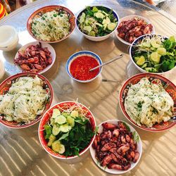 High angle view of various food in bowls on table