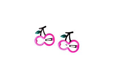 Toy riding bicycle on pink background