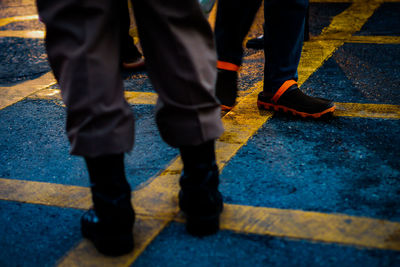 Low section of people standing on road