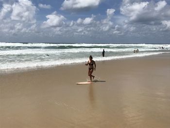 People on beach against sky