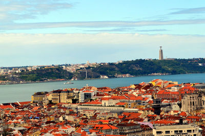 High angle view of townscape by sea against sky