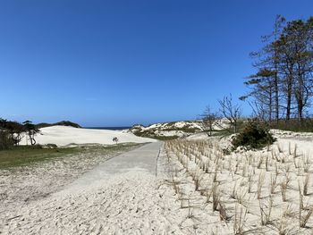 Scenic view of land against clear blue sky