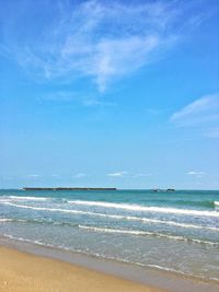 Scenic view of beach against blue sky