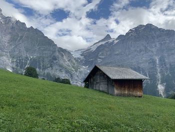 Scenic view of field and mountains against sky