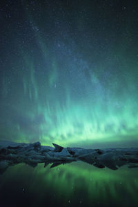 Scenic view of snowcapped mountains against sky at night