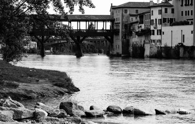 View of bridge over river against buildings