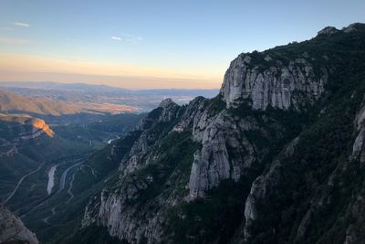 Scenic view of rocky mountains against sky during sunset