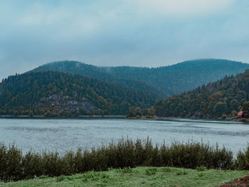 Scenic view of lake and mountains against sky