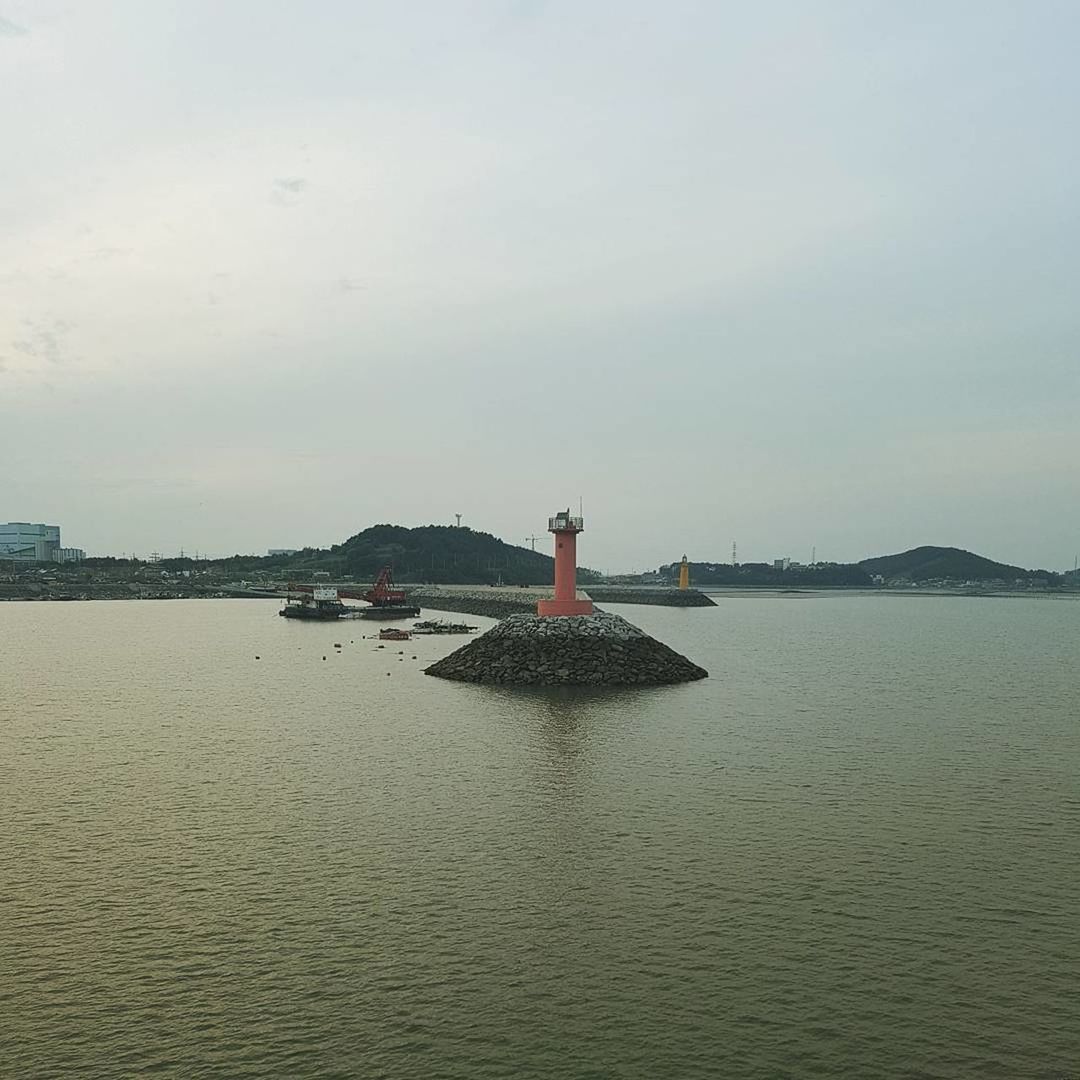 LIGHTHOUSE ON SEA AGAINST SKY