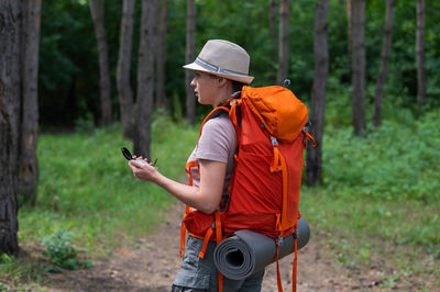 Rear view of man standing in forest