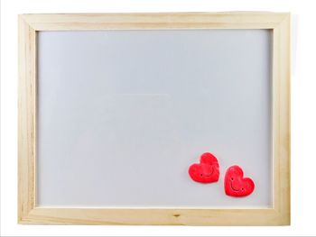 Close-up of red heart shape on white background