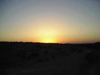 Scenic view of silhouette landscape against clear sky during sunset