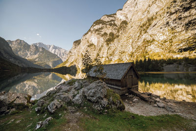 Scenic view of lake by mountain against sky