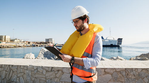 Engineer takes notes on a clipboard