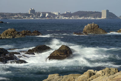 Scenic view of sea and rocks against sky