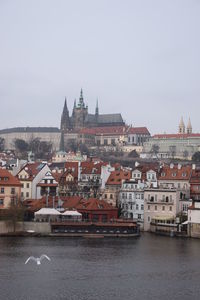 Buildings in city against clear sky