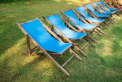 Empty chairs and tables on field