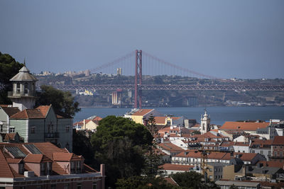 Buildings in city lisbon, iron bridge