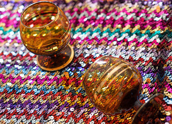 High angle view of multi colored glass on table